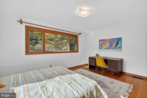 a bedroom with bed and a window