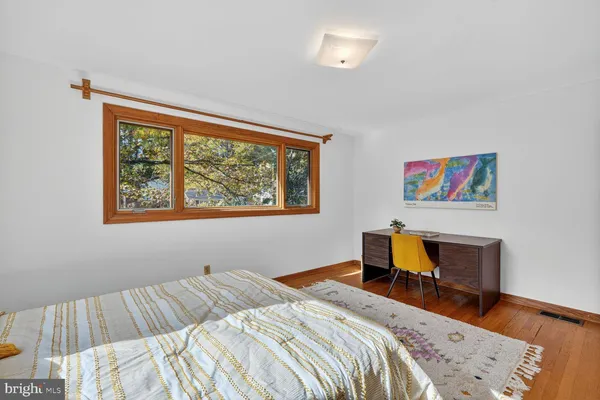 a bedroom with bed and a window