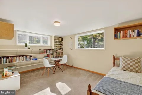 a bedroom with furniture and a book shelf