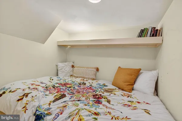 a bedroom with a bed and a book shelf