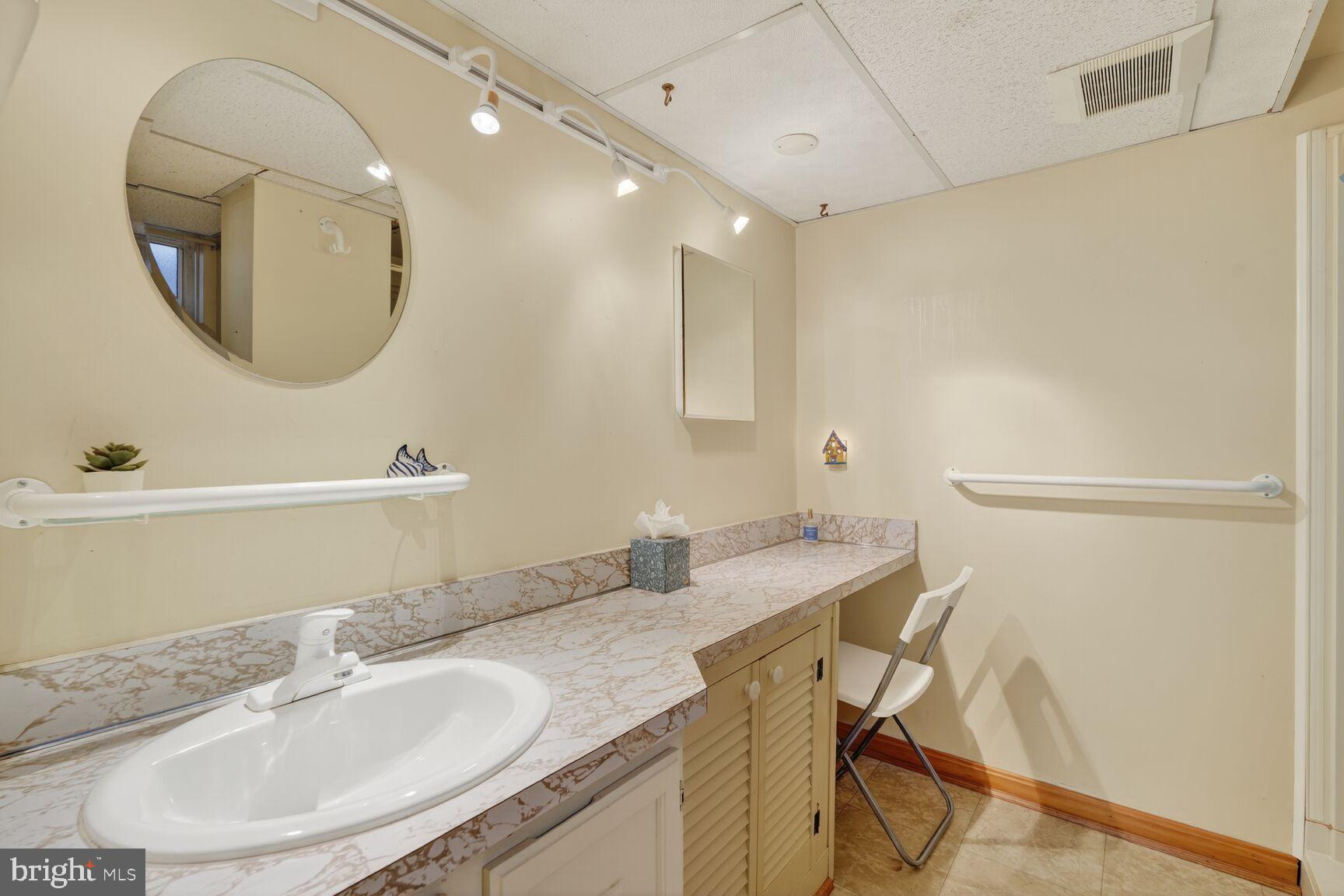 10407 Royal Road Silver Spring, MD 20903 - Photo 25 of 33 a bathroom with a granite countertop sink a mirror and a vanity