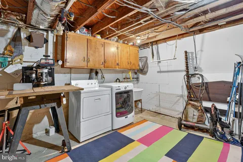 a utility room with sink dryer and washer
