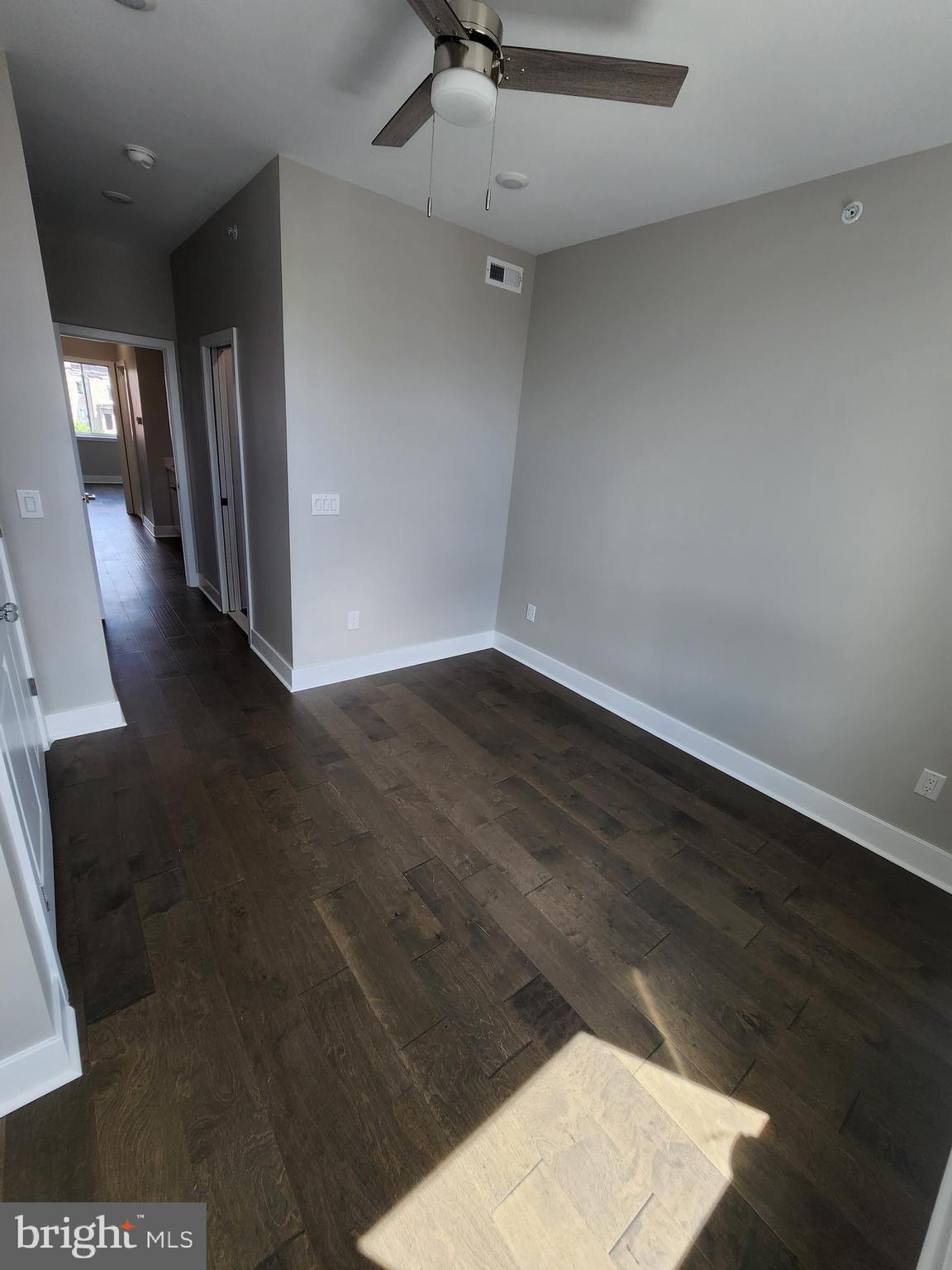 2449 Turner Street, Unit 2 Philadelphia, PA 19121 - Photo 12 of 24 an empty room with wooden floor and windows