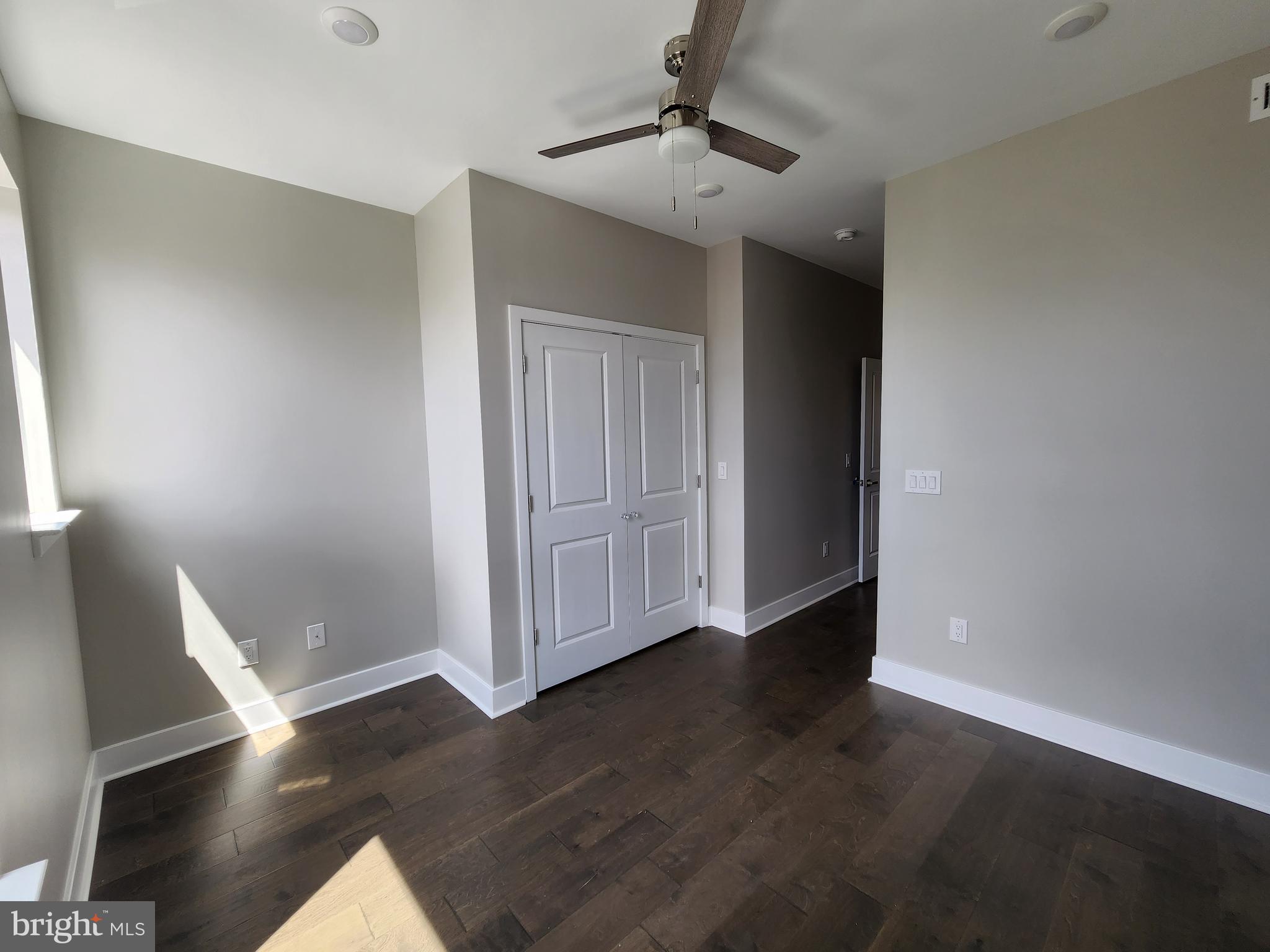 2449 Turner Street, Unit 2 Philadelphia, PA 19121 - Photo 13 of 24 a view of an empty room with wooden floor and a window