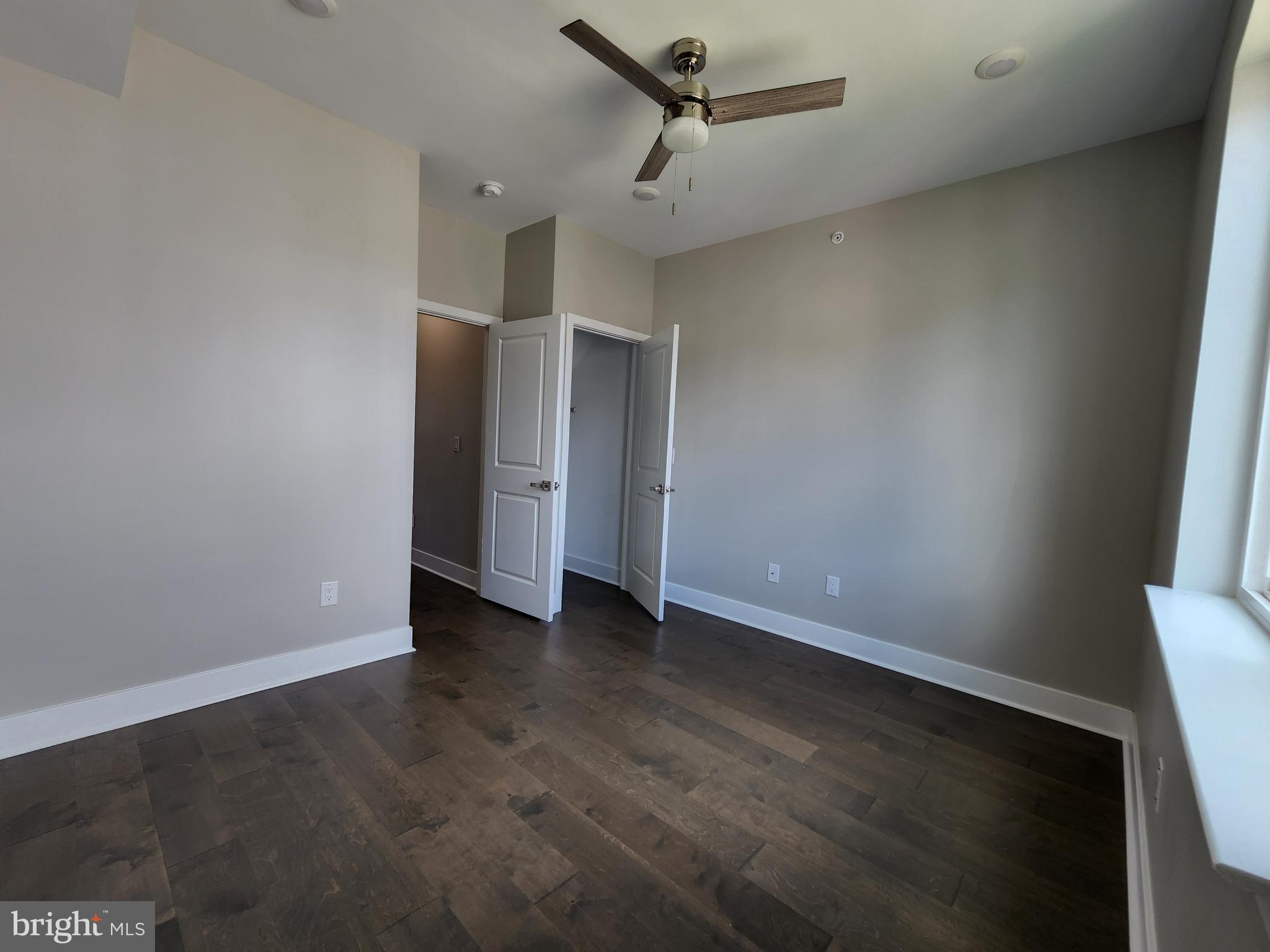 2449 Turner Street, Unit 2 Philadelphia, PA 19121 - Photo 14 of 24 an empty room with wooden floor and windows