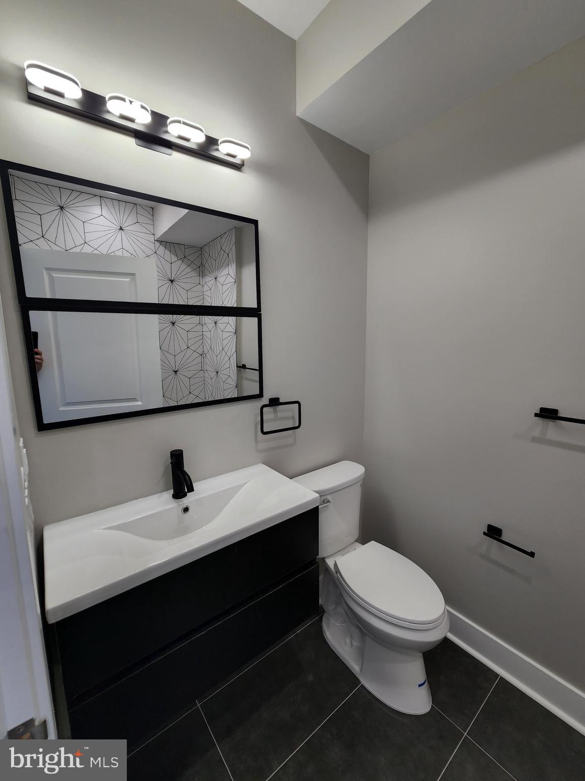 2449 Turner Street, Unit 2 Philadelphia, PA 19121 - Photo 16 of 24 a bathroom with a toilet sink and mirror