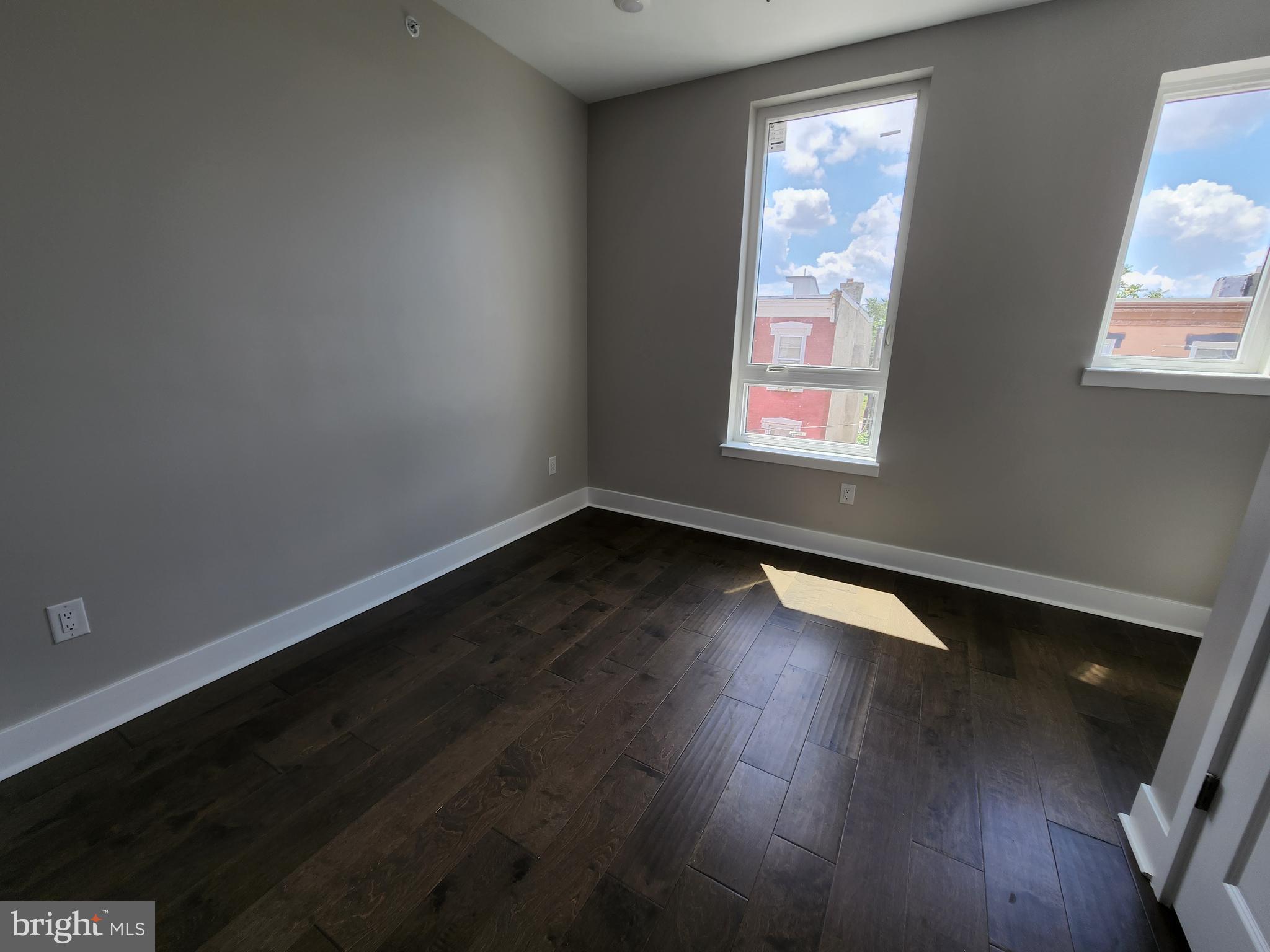 2449 Turner Street, Unit 2 Philadelphia, PA 19121 - Photo 18 of 24 an empty room with wooden floor and windows