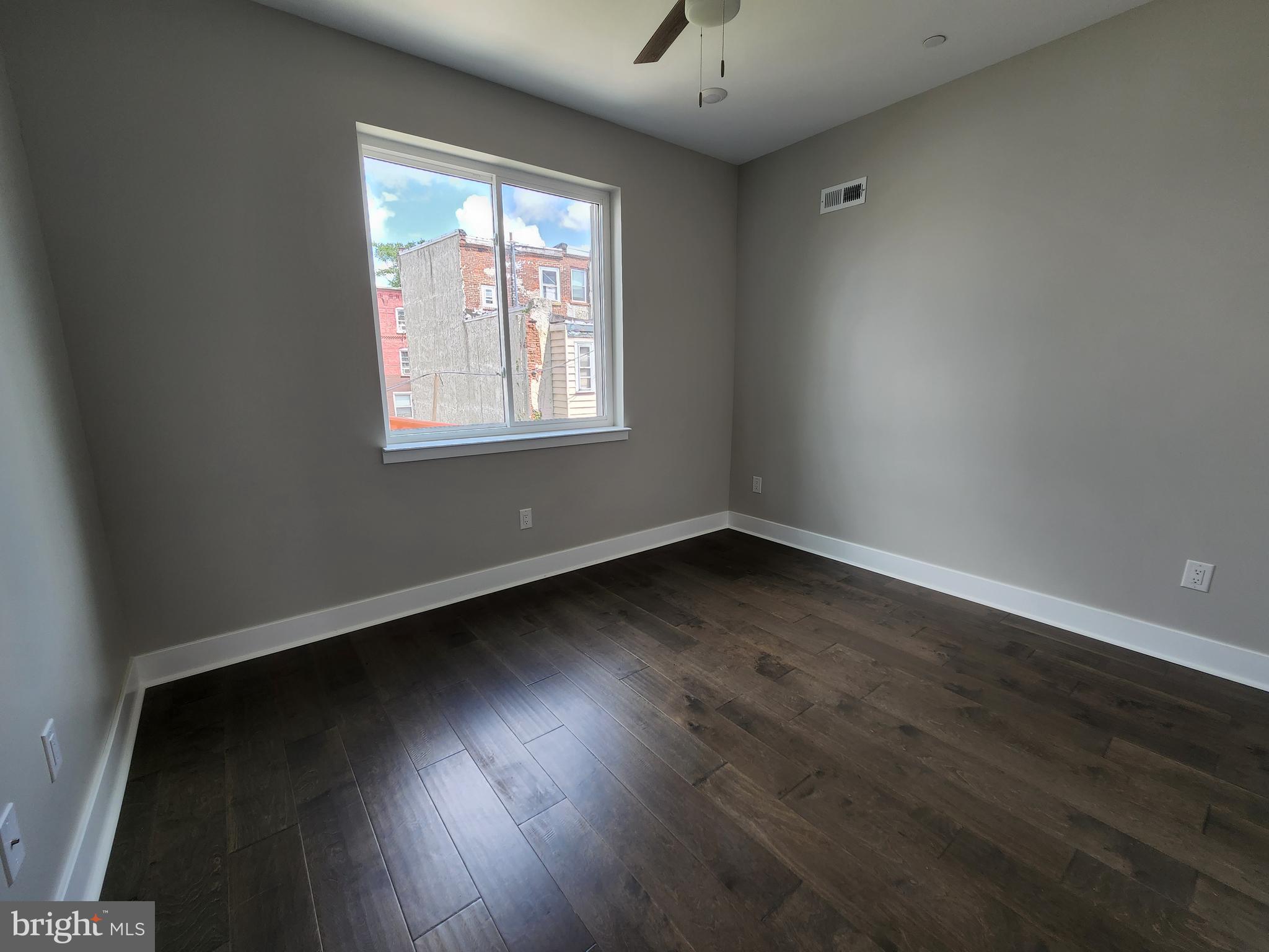 2449 Turner Street, Unit 2 Philadelphia, PA 19121 - Photo 19 of 24 an empty room with wooden floor and windows