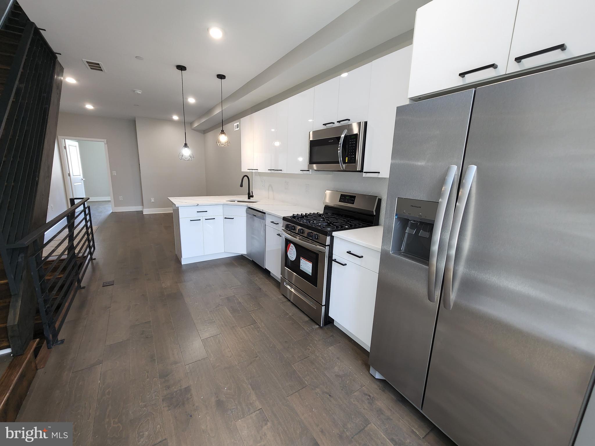 2449 Turner Street, Unit 2 Philadelphia, PA 19121 - Photo 2 of 24 a kitchen with cabinets and stainless steel appliances