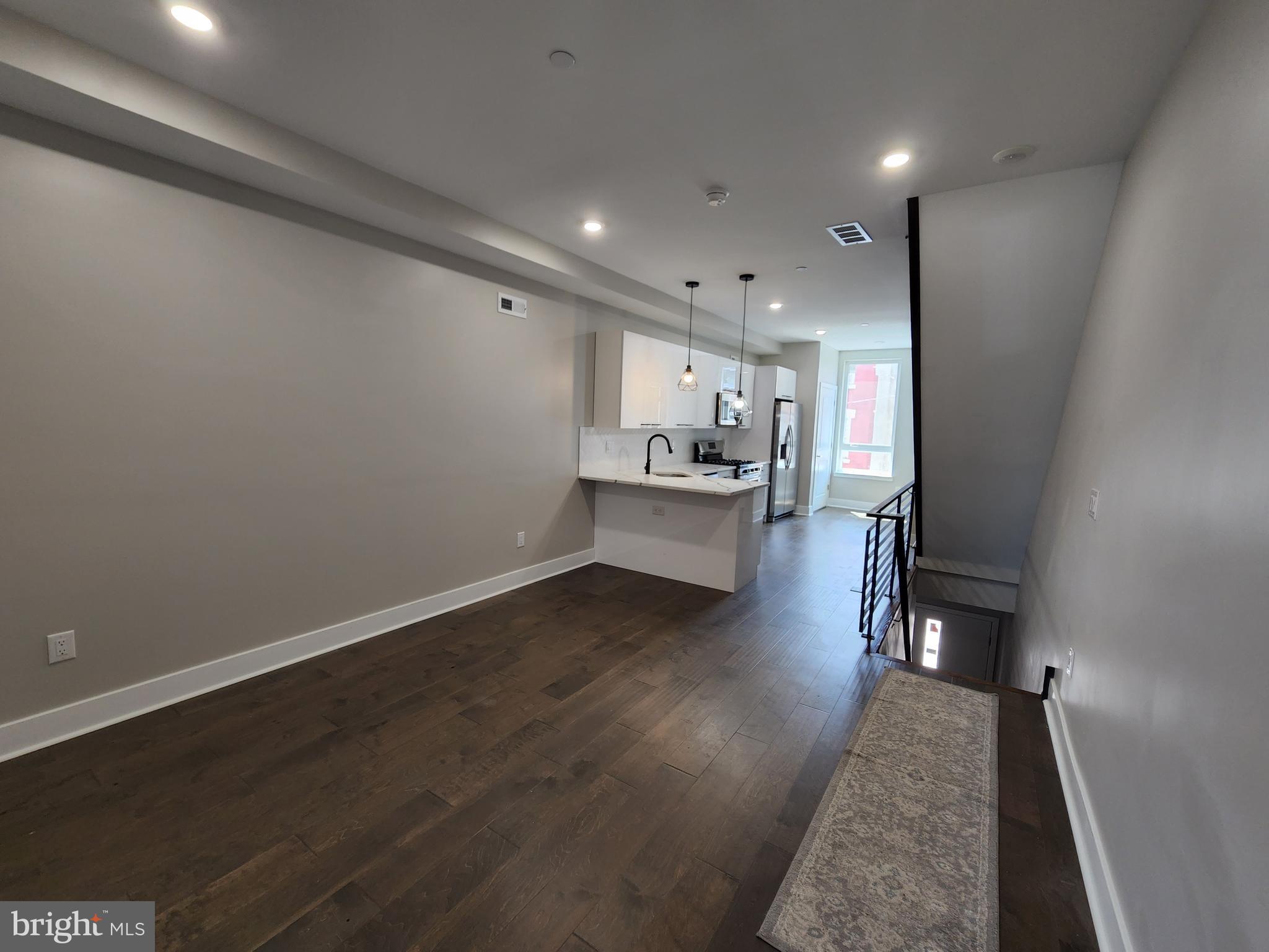 2449 Turner Street, Unit 2 Philadelphia, PA 19121 - Photo 4 of 24 a view of a kitchen with wooden floor and a sink