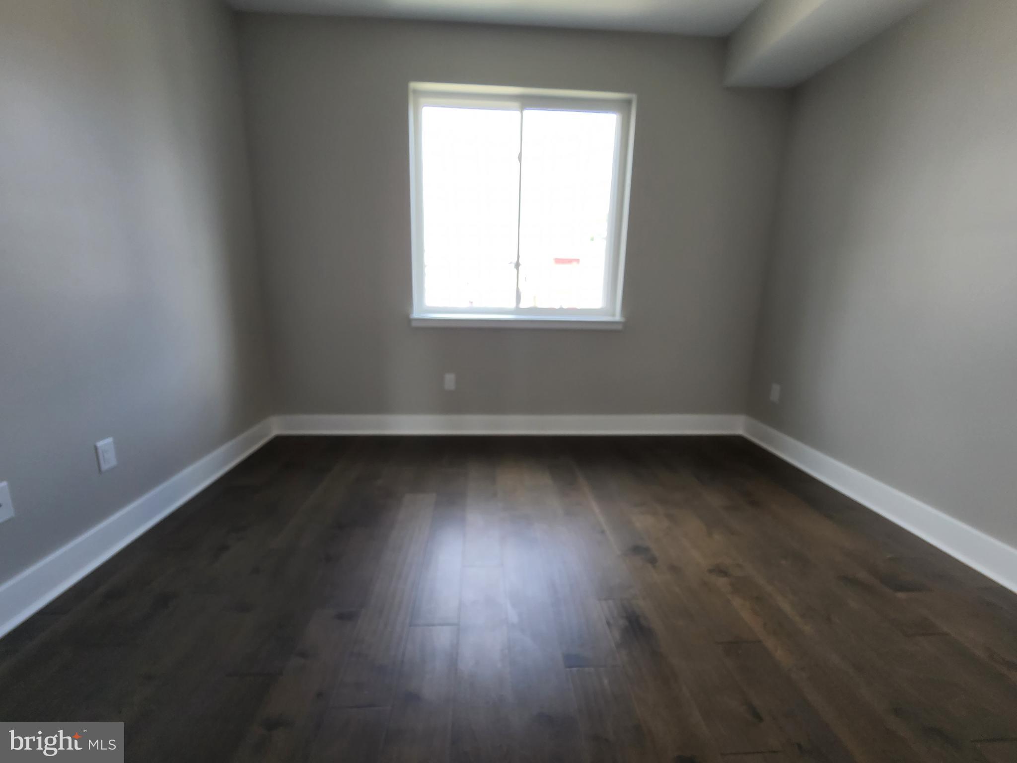 2449 Turner Street, Unit 2 Philadelphia, PA 19121 - Photo 6 of 24 an empty room with wooden floor and windows