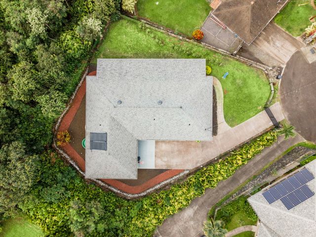 an aerial view of a house with a yard