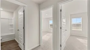 a view of a bathroom from a hallway with toilet