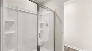 a bathroom with a glass shower door