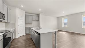 912 Stow Lane Monroe, GA 30655 - Photo 5 of 32 a kitchen with stainless steel appliances granite countertop a sink stove and refrigerator