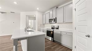 912 Stow Lane Monroe, GA 30655 - Photo 6 of 32 a kitchen with appliances a sink and cabinets