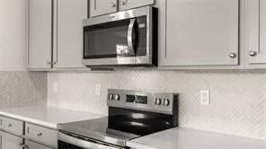 a kitchen with granite countertop white cabinets and white appliances