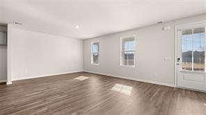 912 Stow Lane Monroe, GA 30655 - Photo 10 of 32 a view of an empty room with wooden floor and a window
