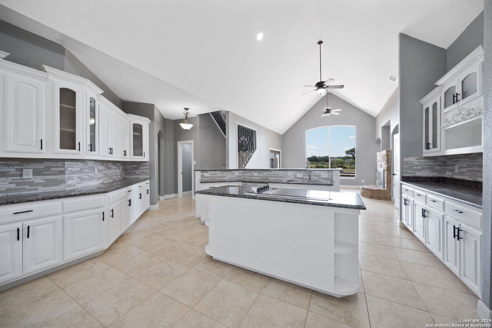 3022 Interstate 35 Natalia, TX 78059 - Photo 15 of 49 a large kitchen with stainless steel appliances kitchen island granite countertop a sink and dishwasher a stove with granite countertops