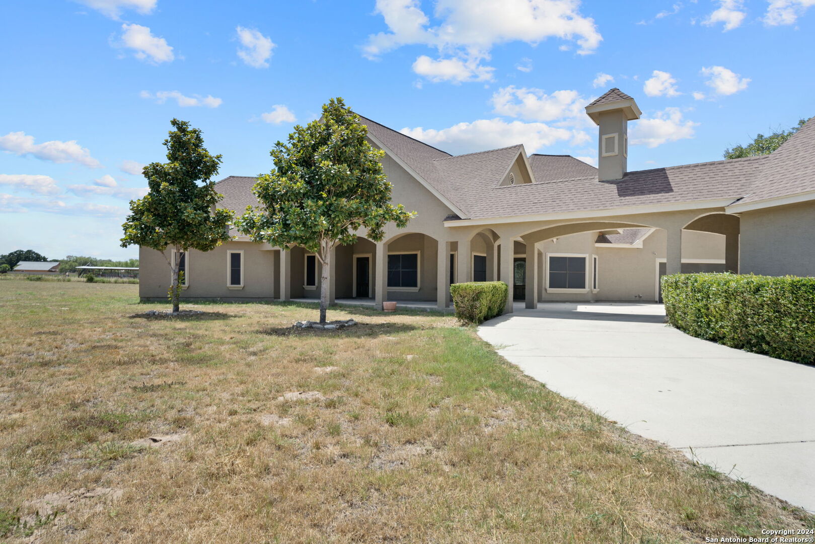 3022 Interstate 35 Natalia, TX 78059 - Photo 2 of 49 a front view of a house with garden