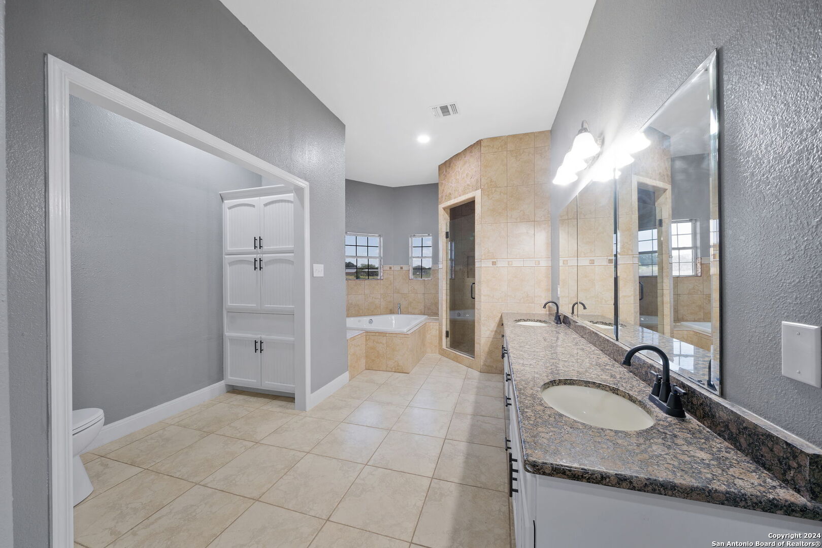 3022 Interstate 35 Natalia, TX 78059 - Photo 23 of 49 a bathroom with a granite countertop sink mirror and shower