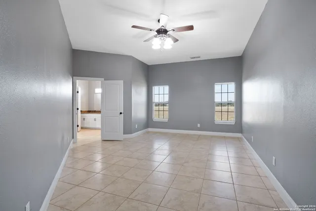 a spacious bathroom with a granite countertop sink mirror and shower