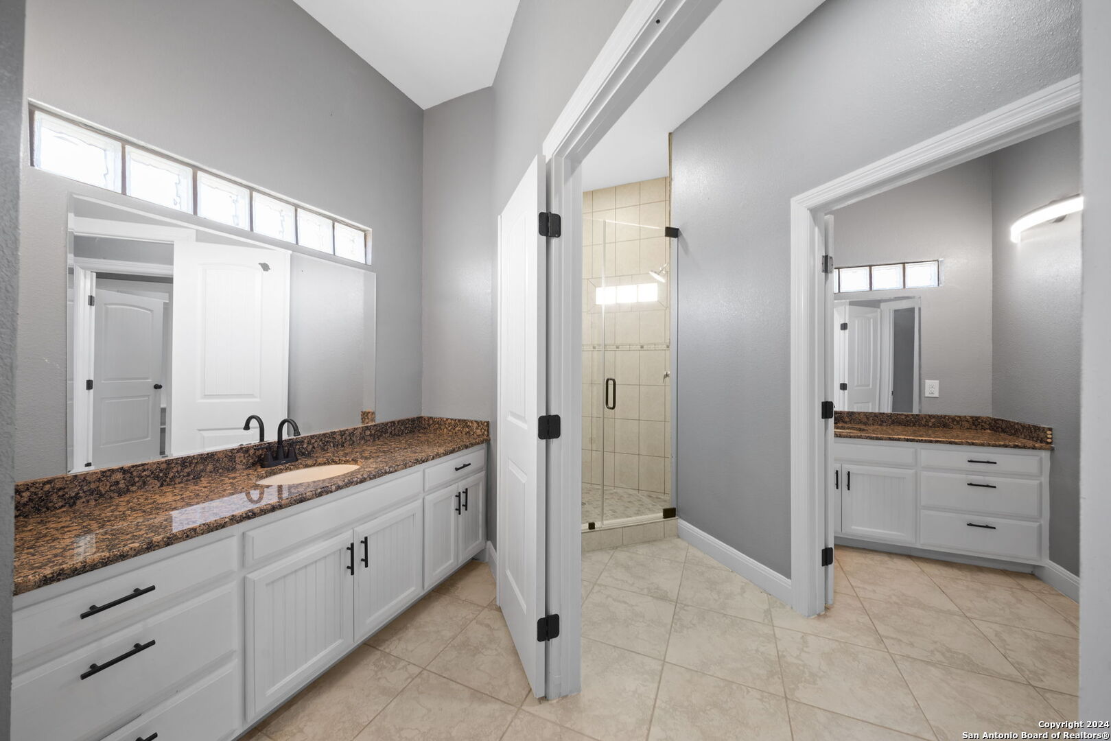 3022 Interstate 35 Natalia, TX 78059 - Photo 27 of 49 a spacious bathroom with a granite countertop sink mirror and shower