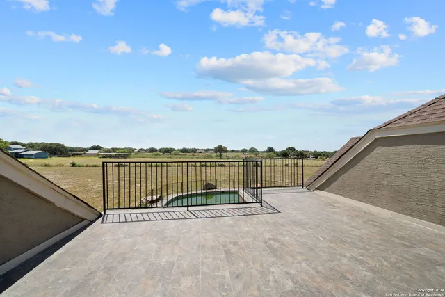a view of a white house with a outdoor space