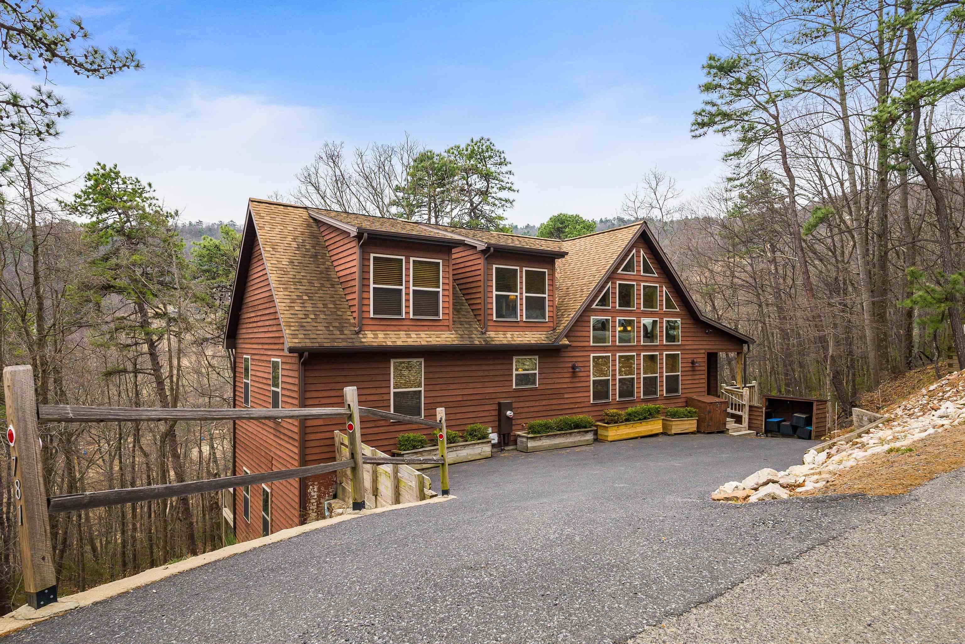 a view of a house with a yard and wooden fence