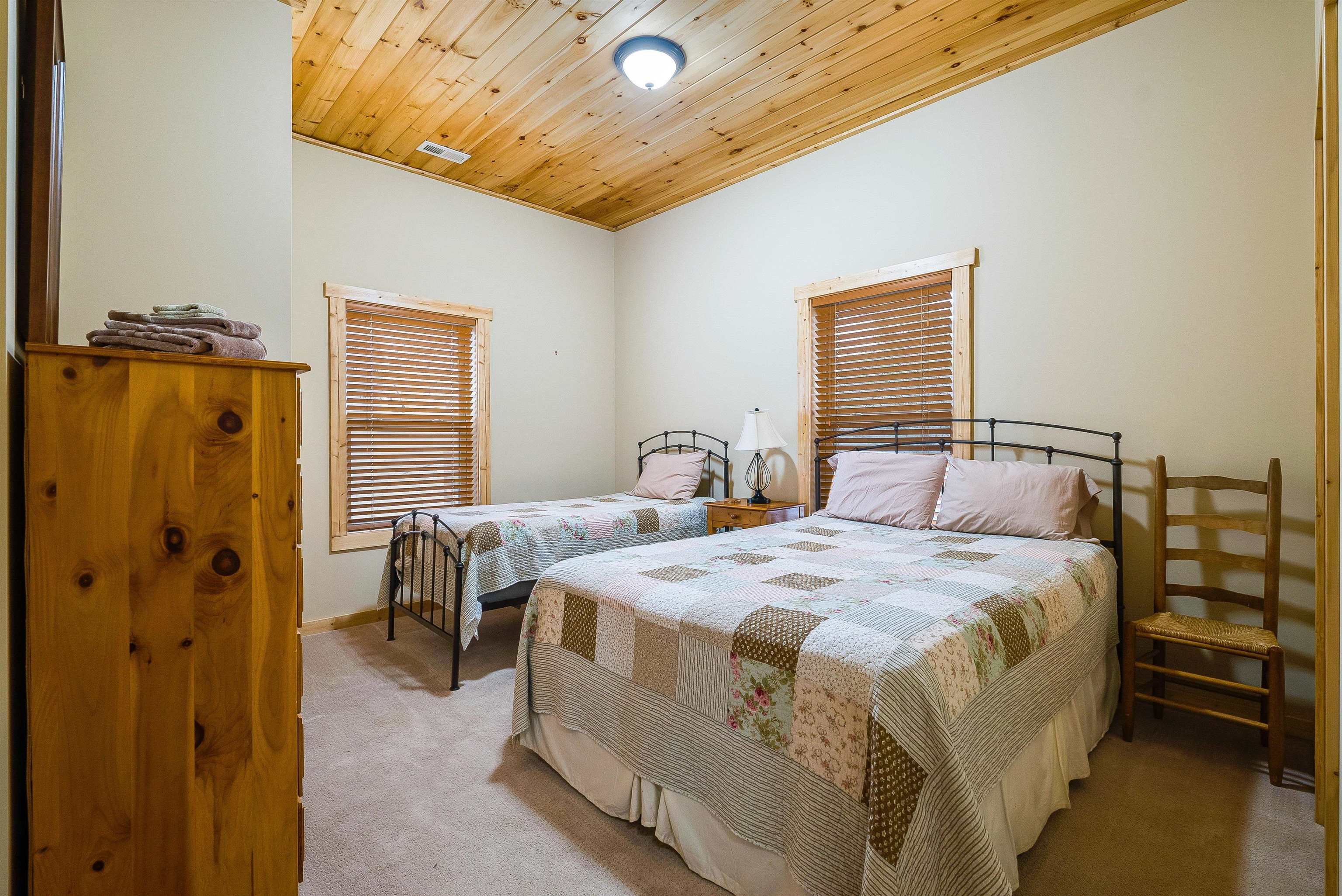 781 Rainier Road McGaheysville, VA 22840 - Photo 37 of 51 a bedroom with a bed and a chandelier