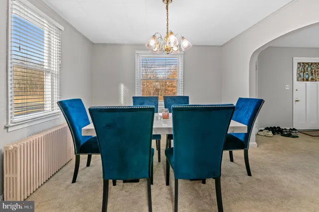 a view of a dining room with furniture and window