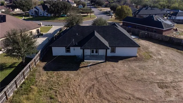 a aerial view of a house with a yard
