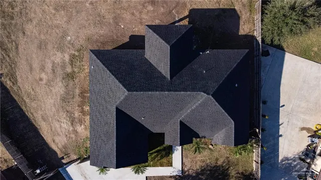 a front view of a house with mountain view and a garden