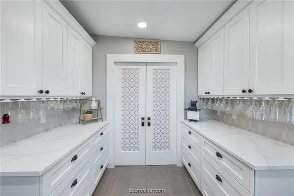 a view of a kitchen with granite countertop white cabinets and a granite counter tops