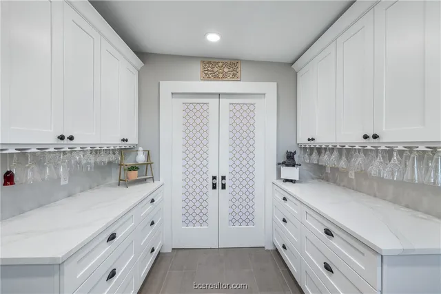 a view of a kitchen with granite countertop white cabinets and a granite counter tops
