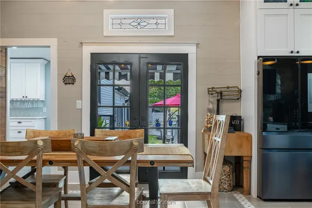 a outdoor dining space with a table and chairs