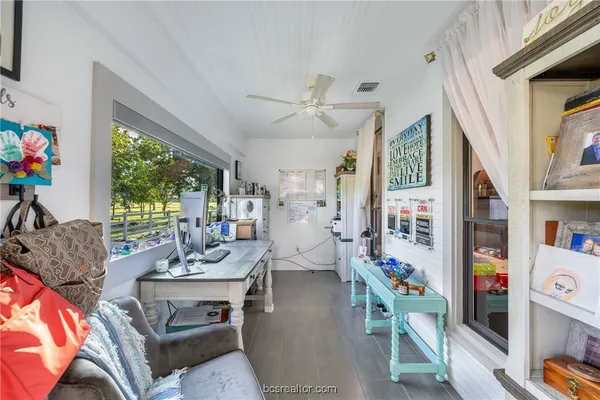 a living room with furniture fireplace and a large window