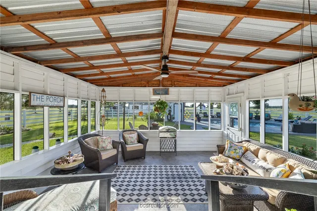 a living room with furniture and outdoor space