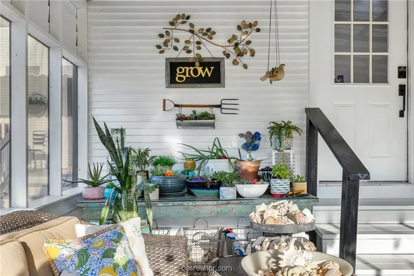 a living room with furniture and flowers