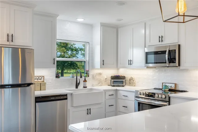 a kitchen with a sink stove and refrigerator