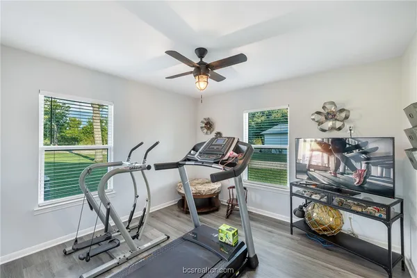 a living room with furniture a flat screen tv and a window