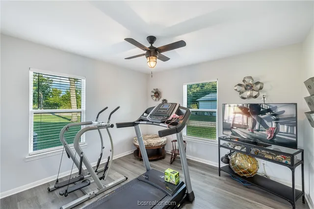 a living room with furniture a flat screen tv and a window