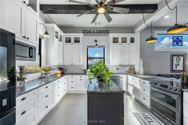 a kitchen with stainless steel appliances a stove a sink and a refrigerator