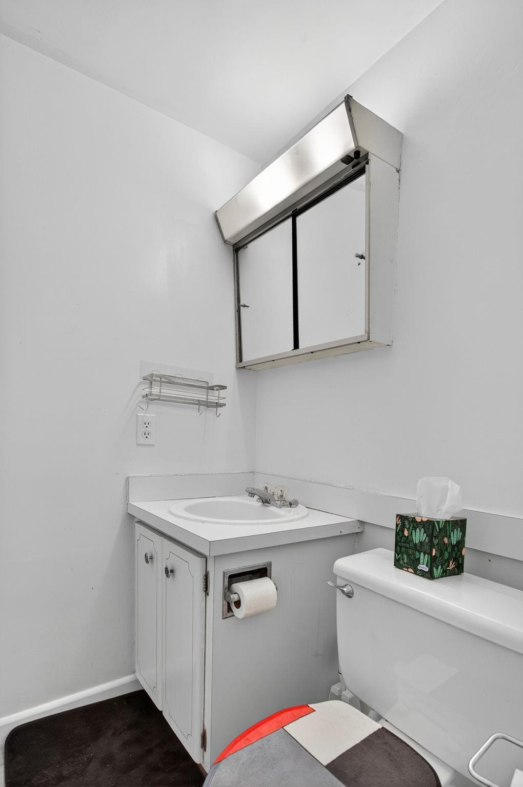 418 South Cypress Road, Unit 110 Pompano Beach, FL 33060 - Photo 16 of 28 a bathroom with a sink toilet vanity and mirror