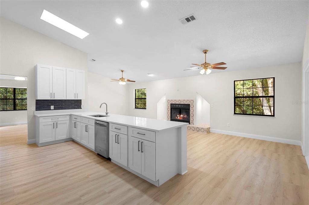 26 Laurianne Road DeBary, FL 32713 - Photo 13 of 41 a large kitchen with a wooden floor and stainless steel appliances
