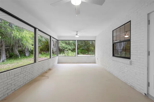 a view of an empty room with windows and balcony