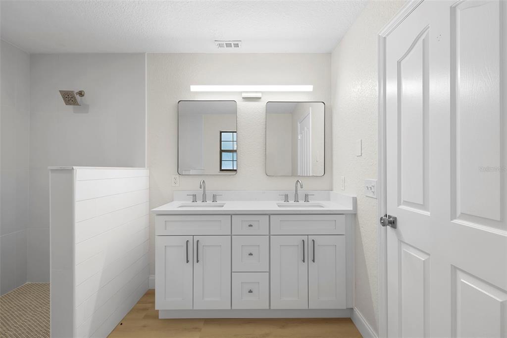 26 Laurianne Road DeBary, FL 32713 - Photo 25 of 41 a bathroom with a double vanity sink and mirror