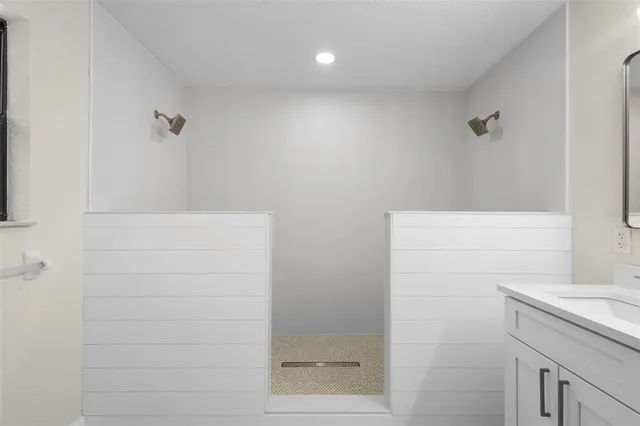 a bathroom with a shower and sink