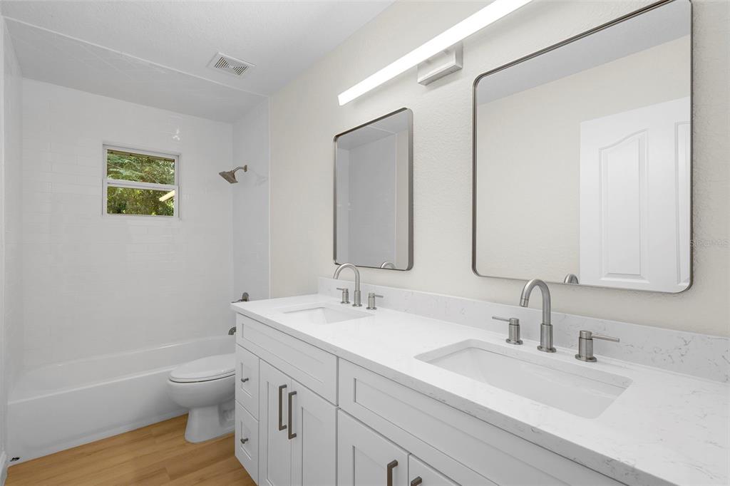 26 Laurianne Road DeBary, FL 32713 - Photo 28 of 41 a bathroom with a sink a toilet and a large mirror