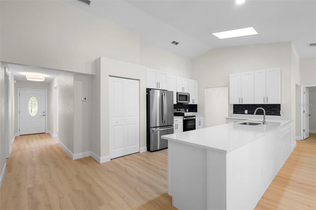 26 Laurianne Road DeBary, FL 32713 - Photo 33 of 41 a kitchen with stainless steel appliances a refrigerator and a stove top oven